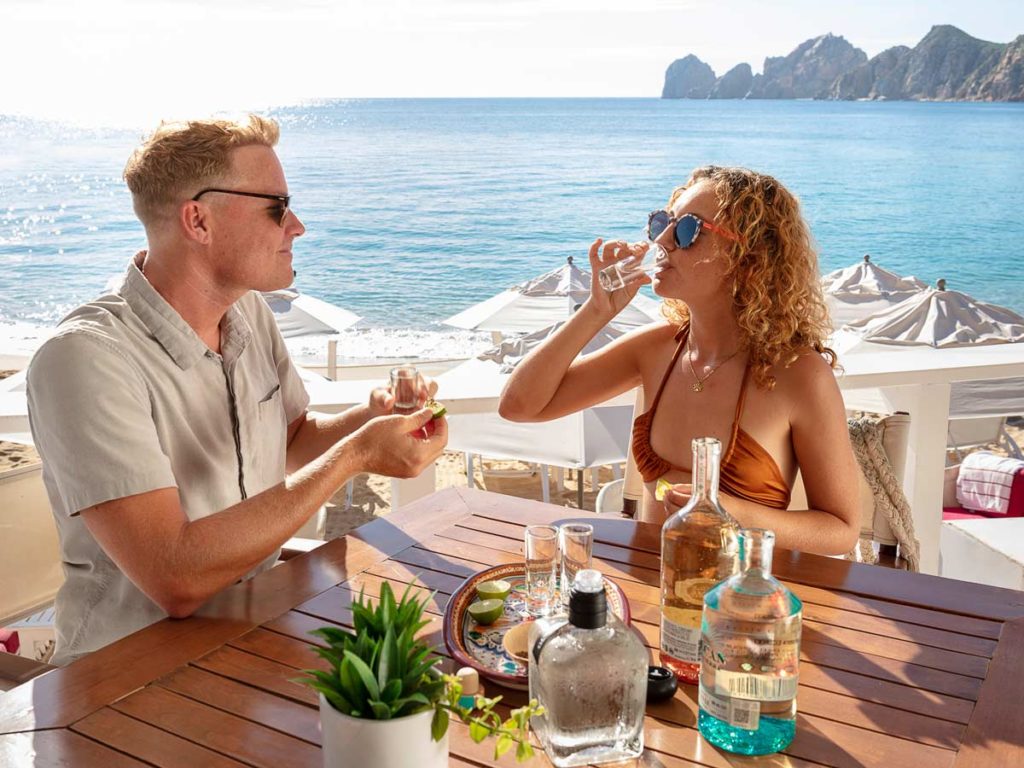 Couple Having Shots By The Ocean.