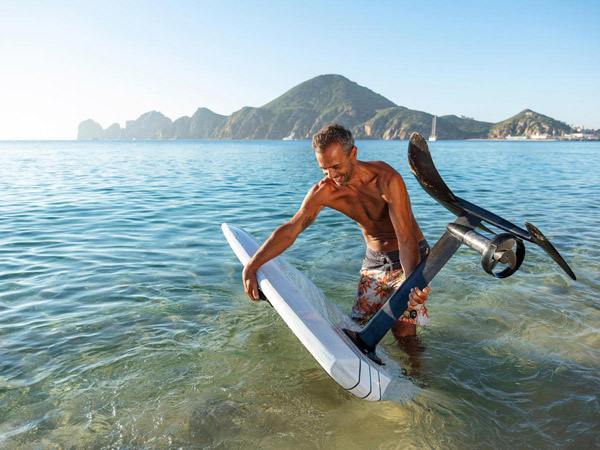 Guy With An Electric Paddleboard In The Ocean.