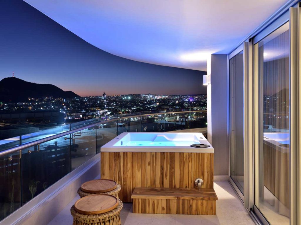 Balcony With Hot Tub And City View.