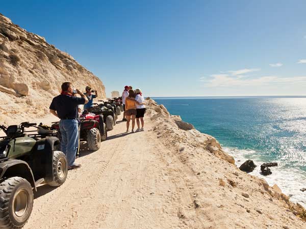 Riding ATVs By The Beach.