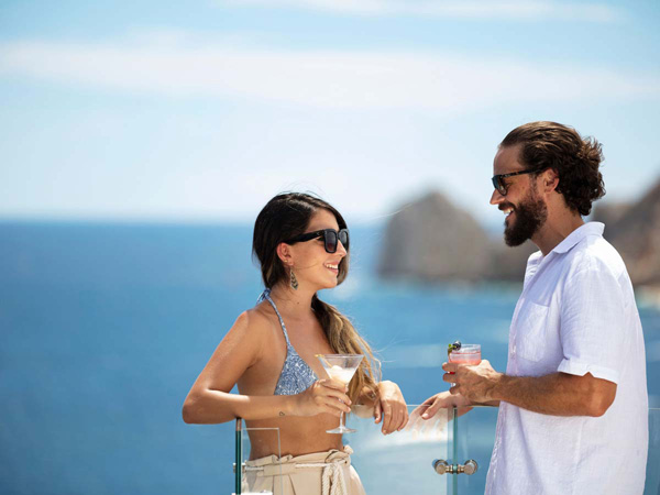Couple Having Cocktails On The Rooftop.