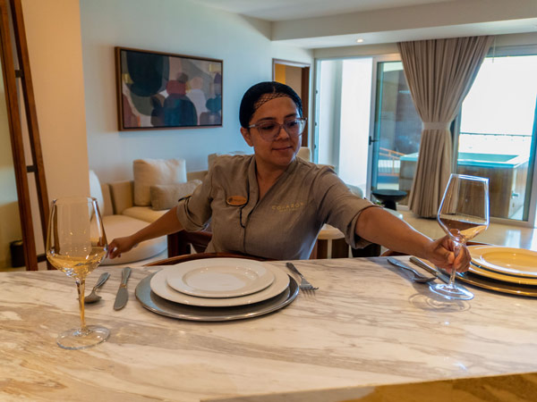 Staff Member Setting Place Settings In A Guestroom