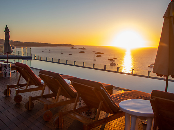 Sunset over the bay from the rooftop infinity pool and lounge deck at Corazon Cabo Resort & Spa in Cabo San Lucas